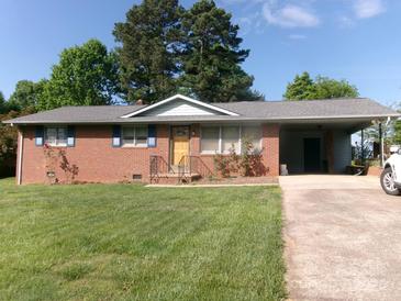 Charming brick home with a covered carport and well-manicured lawn, showcasing its inviting curb appeal at 2583 Robinson Rd, Newton, NC 28658