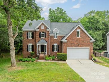 Charming brick home with a well-manicured lawn and two-car garage at 2907 Notchview Ct, Charlotte, NC 28210