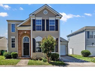 Charming two-story home featuring black shutters, brick accents, and a well-maintained front yard at 8610 Sawleaf Ct, Charlotte, NC 28215