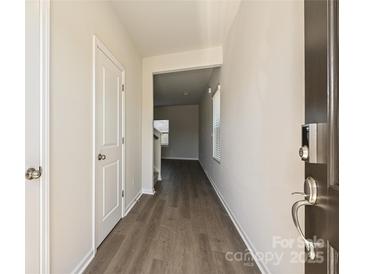 Inviting hallway featuring hardwood floors, neutral paint, and a glimpse into the living area at 111 Canoga Ave, York, SC 29745