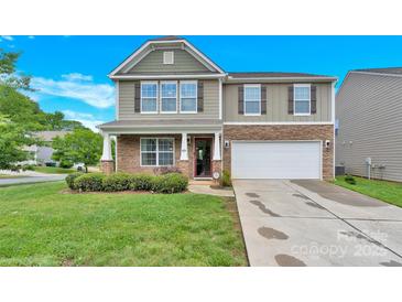 Charming two-story home with stone accents, well-maintained lawn, and attached two-car garage at 12217 Dearview Ln, Charlotte, NC 28269