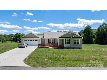 Charming single-story home with a two car garage, handicap ramp, and well-maintained lawn at 125 Carter Ln, Statesville, NC 28625