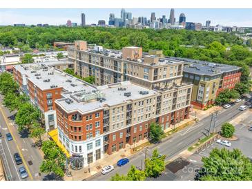 Stunning aerial view of apartment building with skyline in the background at 1315 East Blvd # 410, Charlotte, NC 28203