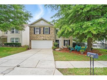 Charming two-story home featuring a brick facade, well-maintained lawn, and inviting curb appeal at 1332 Waterlily Ln, Charlotte, NC 28262