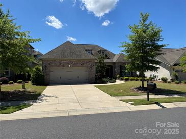 Beautiful brick home with a two-car garage, manicured lawn, and lovely landscaping at 15927 Vale Ridge Dr, Charlotte, NC 28278