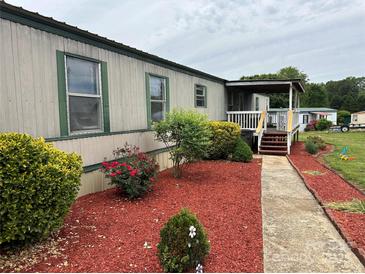 Charming single-story home featuring a cozy front porch and well-maintained landscaping at 181 Trivette Rd, Harmony, NC 28634