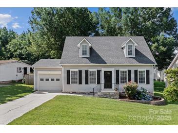 Charming home with grey siding, black shutters, well-maintained lawn, and beautiful landscaping at 20840 Sierra Vista Dr, Cornelius, NC 28031