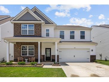 Inviting two-story home with a charming front porch and well-maintained landscaping at 3643 Slider Ter, Lancaster, SC 29720