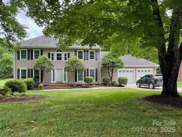 Charming two-story home features a manicured lawn and attached two car garage at 4509 Patriots Way, Gastonia, NC 28056