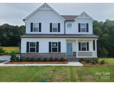 Charming two-story home with a welcoming front porch and classic architectural details at 5630 Galloway Dr # 49, Stanfield, NC 28163