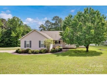 Charming single-story home with manicured lawn, mature tree, and covered front porch at 5678 Cedar Run Dr, Denver, NC 28037