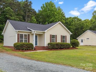 Charming single-story home with well-maintained lawn and detached garage at 6022 Windsong Way, Wingate, NC 28174