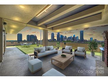 Relaxing rooftop patio featuring comfortable seating and stunning skyline views at 715 N Graham St # 603, Charlotte, NC 28202