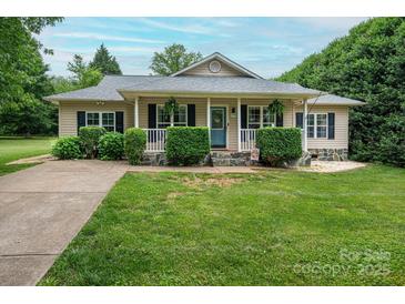 Charming ranch-style home with a welcoming front porch, lush landscaping and a well-manicured lawn at 1774 Smyrna Ln, Catawba, NC 28609