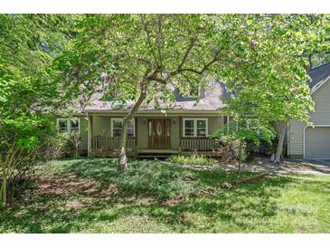 Charming home with a covered front porch and a beautiful, landscaped front yard at 188 Stonemarker Rd, Mooresville, NC 28117