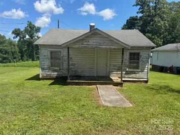 Exterior view of a small, one-story home with a covered porch and visible wear at 204 13Th St, Belmont, NC 28012