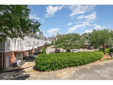 Charming townhomes with manicured landscaping and a glimpse of the cityscape in the background at 216 S Clarkson St # E, Charlotte, NC 28202
