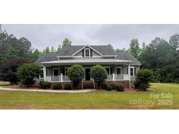 Charming single-story home with a welcoming front porch and manicured landscaping at 230 Shag Bark Ln, Salisbury, NC 28146