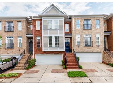 Attractive brick townhome with a well-manicured lawn and attached garages at 3044 Luke Crossing Dr, Charlotte, NC 28226