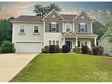 Charming two-story home featuring a well-maintained lawn, blue shutters, and a welcoming front entrance at 3218 Gilroy Dr, Fort Mill, SC 29707