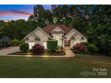 Stunning home featuring manicured landscaping, a charming fountain, and elegant architectural details at 400 Maymont Dr, Cramerton, NC 28032