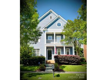 Charming two-story home boasts a welcoming front porch and well-manicured lawn at 4516 Night Heron Ln, Charlotte, NC 28211
