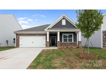 Charming single-story home featuring a stone and gray shingle facade, well-manicured lawn, and a two-car garage at 4619 Harris Elliot Rd, Lincolnton, NC 28092