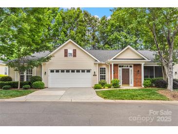 Charming home with attached two-car garage, brick entryway, and lush green lawn at 9430 Duckhorn Dr, Charlotte, NC 28277