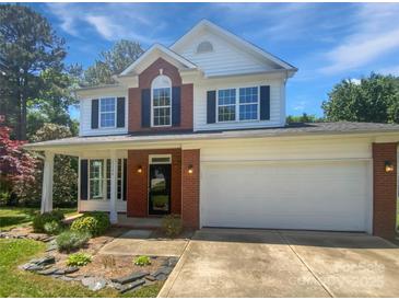 Charming two-story home featuring a two-car garage, complemented by a well-manicured lawn and beautiful landscaping at 1184 Lempster Nw Dr, Concord, NC 28027