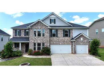 Charming two-story home with a brick facade, two-car garage, and well-manicured lawn at 1281 Arges River Dr, Fort Mill, SC 29715