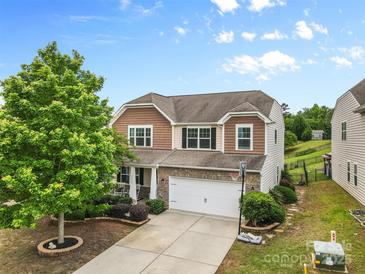 Charming two-story home featuring a two-car garage, well-maintained landscaping, and beautiful curb appeal at 2042 Newport Dr, Fort Mill, SC 29707