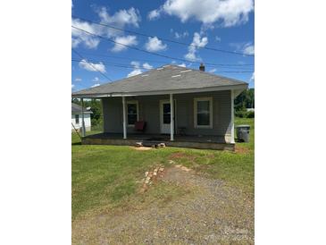 Charming single-story home with a front porch and a well-maintained lawn under a bright blue, sunny sky at 206 13Th St, Belmont, NC 28012