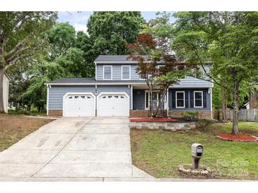 Charming two-story home featuring a two-car garage, landscaped front yard, and inviting curb appeal at 2112 Flint Glenn Ln, Charlotte, NC 28262