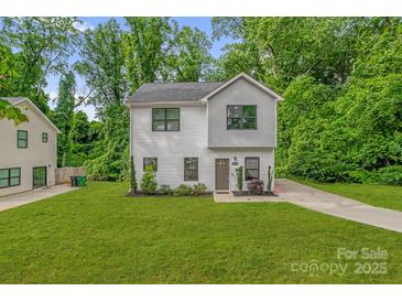 Charming two-story home with a well-manicured lawn and fresh landscaping at 2908 Burgess Dr, Charlotte, NC 28208