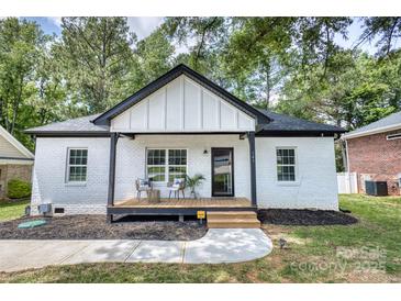 Charming white brick home with a cozy front porch, perfect for enjoying the outdoors at 141 Ole Eastpointe Dr, York, SC 29745