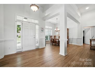 Bright foyer with hardwood floors, a front door with sidelights, and an adjacent dining area at 146 Burtons Barn Rd, Mooresville, NC 28115