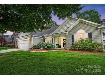 Charming single-story home with a well-manicured lawn and inviting front entrance with a beautiful front flowerbed at 146 Burtons Barn Rd, Mooresville, NC 28115
