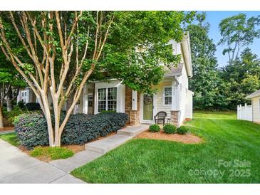 Charming home with a lush front yard and inviting entrance with decorative stone accents and a small sitting area at 541 River Park Rd, Belmont, NC 28012