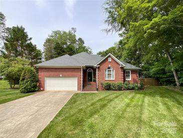 Charming single-story brick home featuring a well-manicured lawn and a two-car garage at 8105 Rachel Ct, Waxhaw, NC 28173