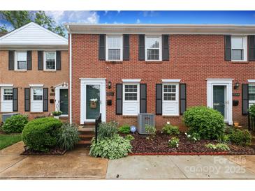 Charming brick townhome with black shutters and landscaped front yard at 8306 Knights Bridge Rd, Charlotte, NC 28210