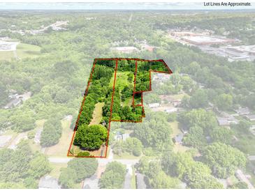 Aerial view showcasing the approximate lot lines of a spacious and heavily wooded property at 84 Sumner Nw Ave, Concord, NC 28027