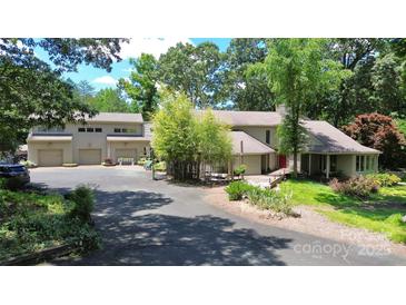 Inviting home exterior featuring mature landscaping, a circular driveway and multiple car garage at 9625-A Surface Hill Rd, Mint Hill, NC 28227