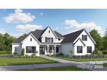 Stunning two-story white home featuring black shutters, complemented by professional landscaping and a well-manicured lawn at 04 Lurecliff Pl, Fort Mill, SC 29708