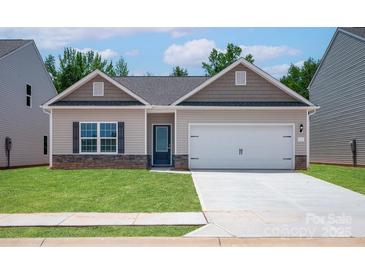 Charming single-story home featuring stone accents, a two-car garage, and a well-manicured front lawn at 1510 Doran Ter, Richburg, SC 29729