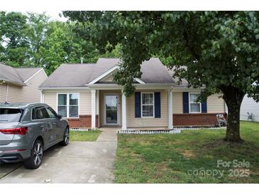 Charming single-story home with a well-manicured lawn, classic architecture, and a welcoming front entrance at 1623 Flagler Ln, Charlotte, NC 28216