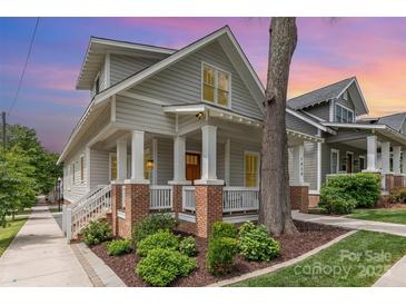 Charming two-story home with gray siding, brick accents, and a welcoming front porch at 1830 Wickford Pl, Charlotte, NC 28203