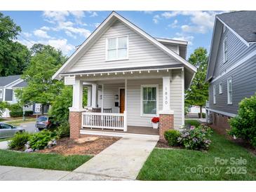 Charming home with welcoming front porch and manicured lawn at 1830 Wickford Pl, Charlotte, NC 28203