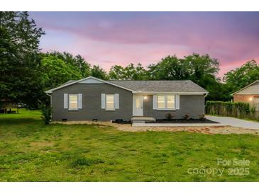 Charming single-story home featuring a brick facade, white trim, and a well-manicured lawn at 2511 Linwood Rd, Gastonia, NC 28052