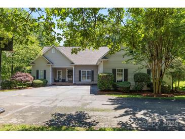 Charming single-story home with manicured landscaping and a spacious driveway at 327 Wilby Dr, Charlotte, NC 28270