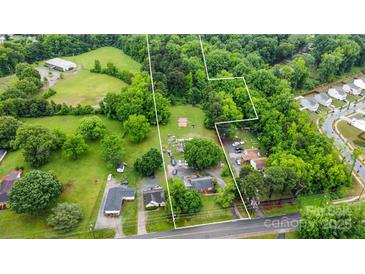 Expansive aerial view of the property showcasing its natural surroundings and proximity to neighborhood at 3700 Nevin Rd, Charlotte, NC 28269